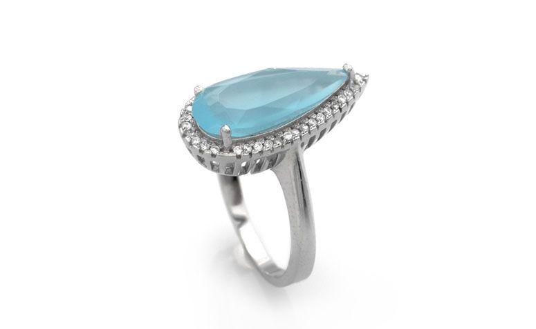 Anel gota quartzo azul por R$ 96,00 <a href="http://www.lumae.com.br/aneis/anel-em-prata-com-rhodium-quartzo-azul-gota-com-borda-cravejada " target="_blank">Lumaê</a>